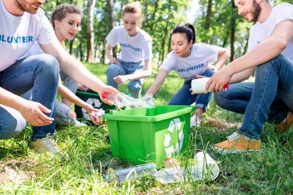 young-volunteers-with-recycling-box-cleaning-lawn-together.jpg